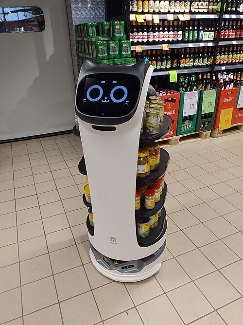 Full-length Pudu BellaBot serving robot in a shop